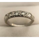 An 18 carat white gold ring set with 7 diamonds. 2.7gms.