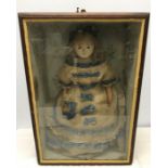 A 19thC large wax head doll wearing a cotton dress with lace in a stained pine display case, 69cms h