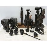 Collection of African carved ebony, elephants, gazelles and tribal figures. Tallest elephant 21cms