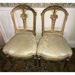 A pair of gilt painted chairs.