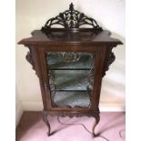 An Edwardian ornately decorated display cabinet with single glazed door. 71 w x 129cms h x 37cms d.