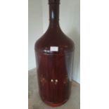 A novelty hardwood drinks cabinet shaped in the form of a large bottle. The two doors opening to