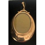 A yellow metal locket, marked to interior metal box, 9ct rim. 5.3gms total.