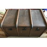 A wooden bound vintage trunk, MC to the top.