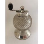 A Victorian silver and cut glass Peugeot pepper grinder with ebony knob handle. Hallmarked London