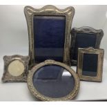 Five silver photograph frames, largest 18 x 13cms.