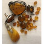 A quantity of amber including 2 necklaces, earrings, ring, brooch, pendant, many mounted on white