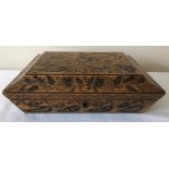 A Regency penwork sarcophogus shaped box decorated with foliage, brass ring drop handles and paper