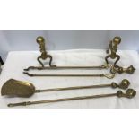 Set of brass fire irons, ball and claw handles with a pair of brass firedogs.