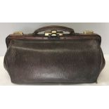 A brown leather Gladstone bag with fittings. 38 w x 24cms h.