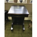 An ebonised Victorian Davenport desk with brass gallery to back, door to side opening to reveal