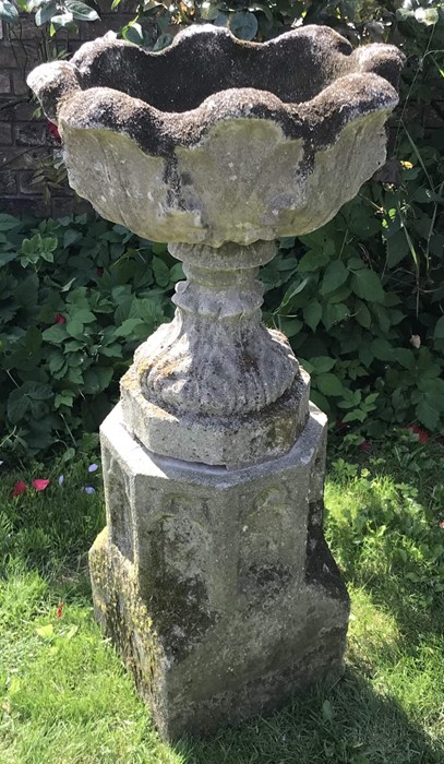 A reconstituted stone planter on octagonal pedestal. 97 h x 49cms d.