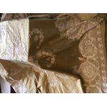 A large double bedspread with cream lace over a gold silk fabric. 231cms square.Condition