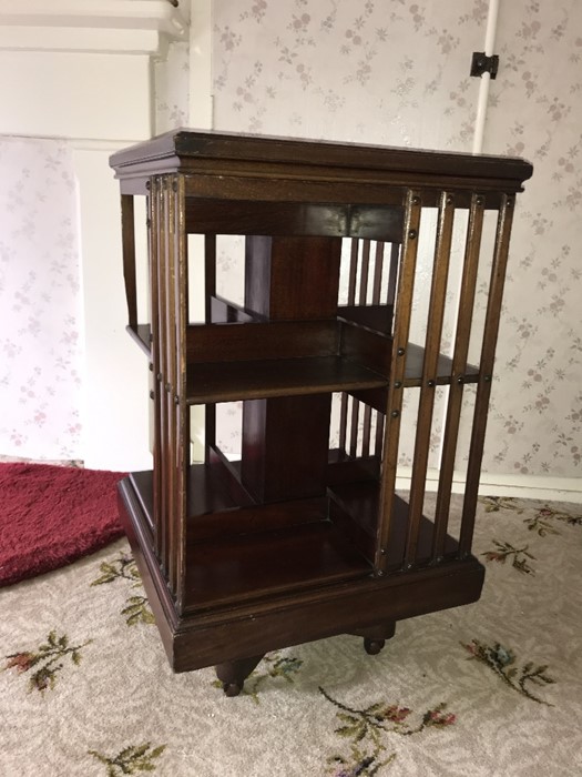 An Edwardian mahogany revolving bookcase. Condition ReportOne strut a/f.