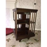 An Edwardian mahogany revolving bookcase. Condition ReportOne strut a/f.