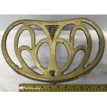An Art Nouveau brass trivet. 16 h x 23cms w.