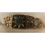 A 9 ct gold ring set with opals, diamonds and emerald. Size O. 2gms.