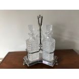 Silver plated 3 bottle decanter stand. Egyptian Sphinx feet. 38cms h. Condition ReportBottle