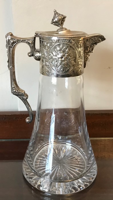 A silver topped claret jug, London 1997. Maker W.W Bacchus head pourer and floral decoration, finial