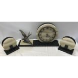 A French Art Deco two colour marble and onyx clock garniture with circular dial mounted to one