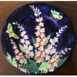A Maling plate depicting flowers and butterflies, 28cms d.