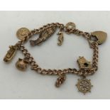 A 9 carat gold charm bracelet 29.7gms with eight 9 ct charms.