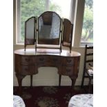 A burr walnut kidney shaped kneehole dressing table together with 3 fold dressing table mirror.