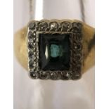 An emerald and diamond ring set in yellow metal, tested as 18ct. Size S.