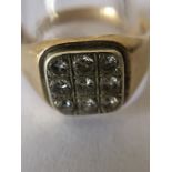 A yellow metal ring set with 9 diamonds tested as 14ct. 11.7gms. Condition ReportMarks rubbed.
