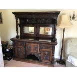 A carved oak mirror backed sideboard, carved lion masks and panelled sides. 180 w x 196 h x 70cms d.