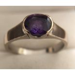 An 18ct white gold ring set with single amethyst, size W, 6.5gms.