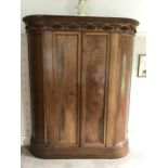 A continental fruitwood double wardrobe with 2 doors and curved sides, single shelf and a hanging