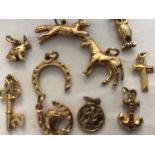 Ten 9ct gold charms, 14.7gms to include horse, owl, rabbit, fox etc.