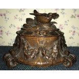 A late 19thC decorative carved wooden jewellery box with bird in nest to top and original blue