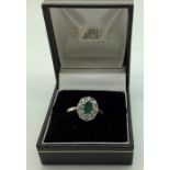 A diamond and emerald cluster ring set in 9 carat gold, centre emerald surrounded with diamonds. 2.