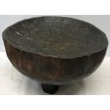 African solid carved wood mixing bowl on tripod feet. 20 h x 34cms w.