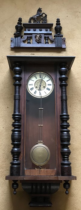 Large pendulum wall clock, porcelain dial with brass decoration. 137cms h including pediment.