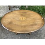 A 19thC oval mahogany tip top looe table with inlaid oval to centre.
