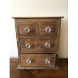 A miniature pine and mahogany 3 height chest of drawers, 2 short over 2 long drawers with glass
