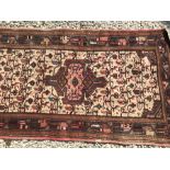 Red patterned wool runner rug. 276cms l x 79cms w.