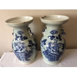 A pair of blue and white Chinese vases a/f. 34cms h. (possibly 18thc)