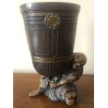 A 19thC Japanese bronze vase. 17cms h. A man holding a large jar.