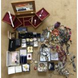 A large quantity of costume jewellery and watches to include brooches, earrings, silver etc.