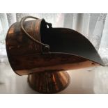A 19thC copper coal helmet. 56 l x 34cms h.