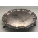 A silver card tray with scalloped edge raised on three feet. 204.1gms. 15.5cms d. Mappin and Webb,