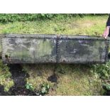 A galvanised metal feeding trough, slightly a/f. 56 w x 48 d x 42 h cms.