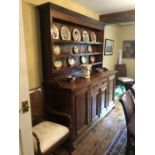 A large 19thC oak dresser, drawers internally and cellarette. Central drawer with 2 doors beneath