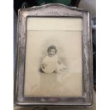 A silver framed photograph frame. 28 x 20cms. Birmingham 1911. Condition ReportSlightly a/f.