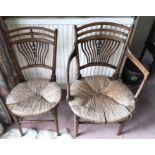 Two late 19thC rush seated chairs, one with arms.