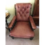 A leather upholstered armchair. 70 w x 98 h x 90cms d.